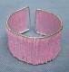 BRACCIALETTO PERLINE RIGIDO. COLORE ROSA./p